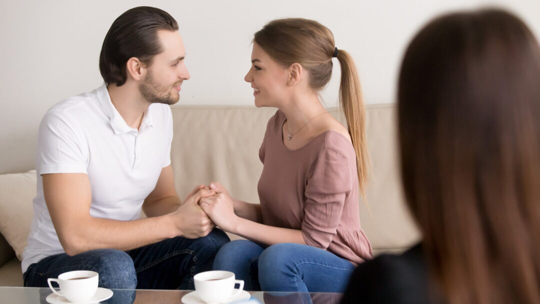 happy-smiling-young-couple-holding-hands-consulting-psychologist-planning-wedding